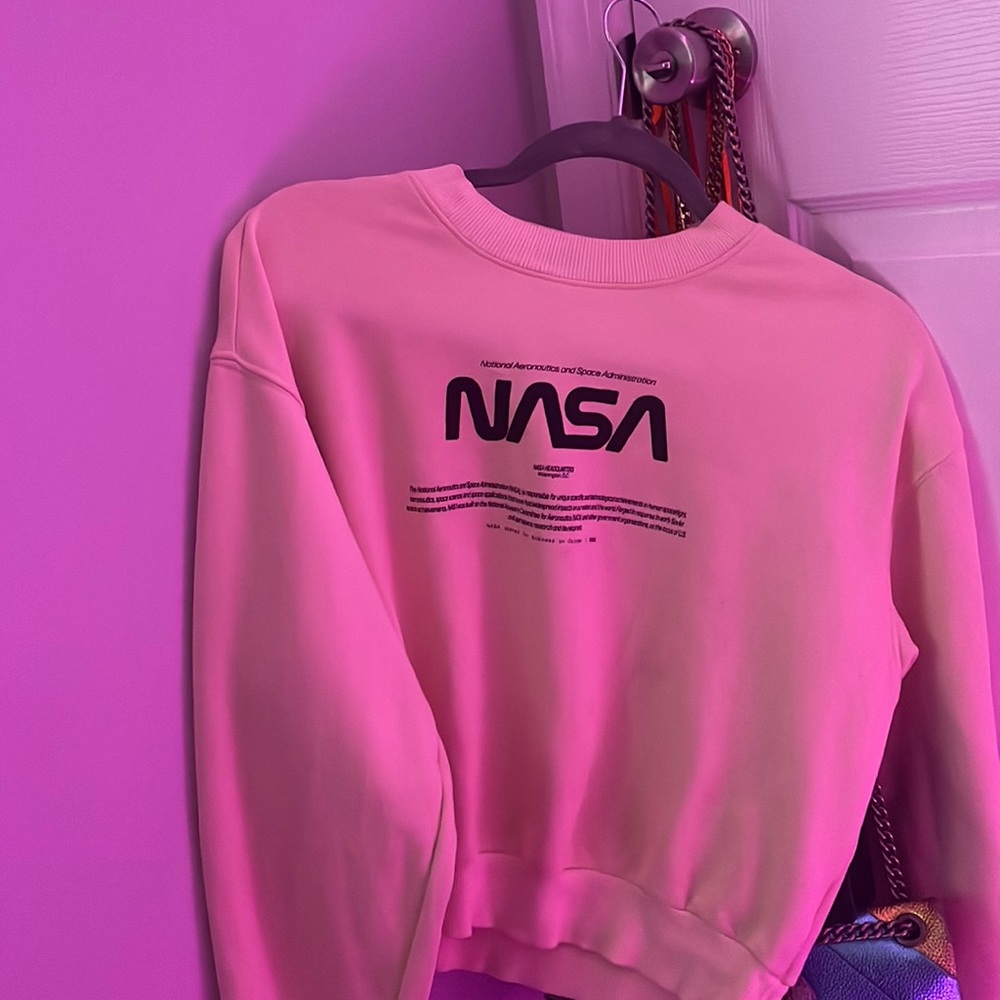 This is a NASA pullover cropped hoodie. It is in the color yellow.